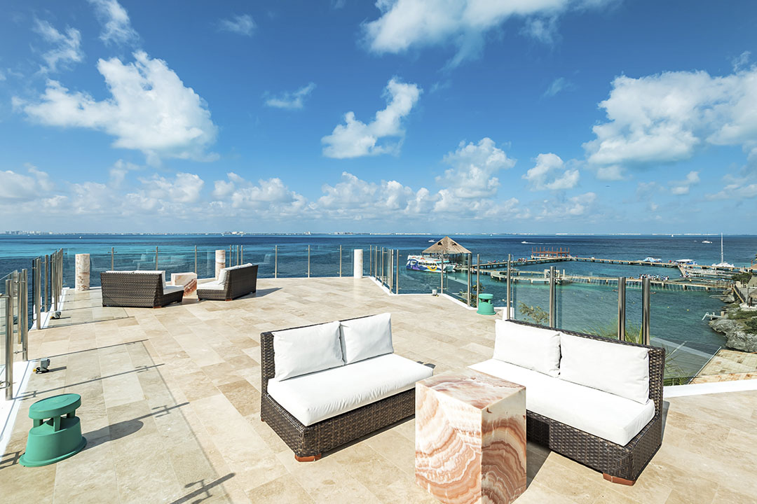 Rooftop lounge and heated jacuzzi with panoramic Caribbean views at Villa Delfines Isla Mujeres
